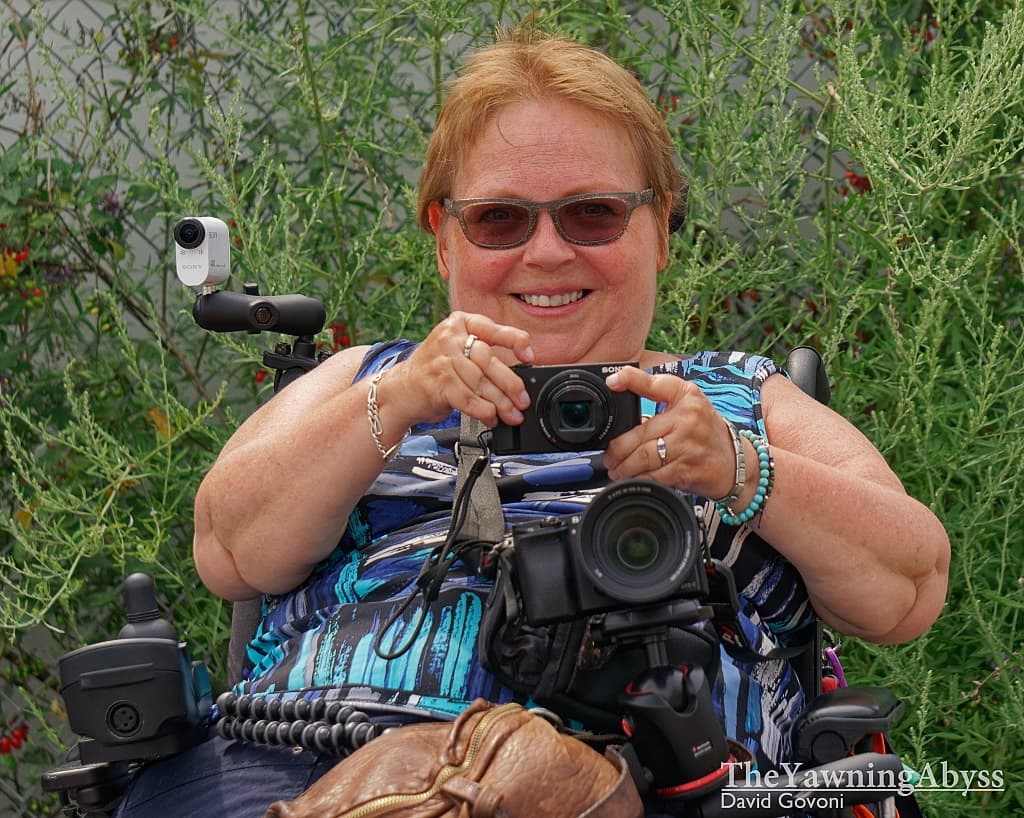 Lene smiling with cameras - as well as smiling at a camera